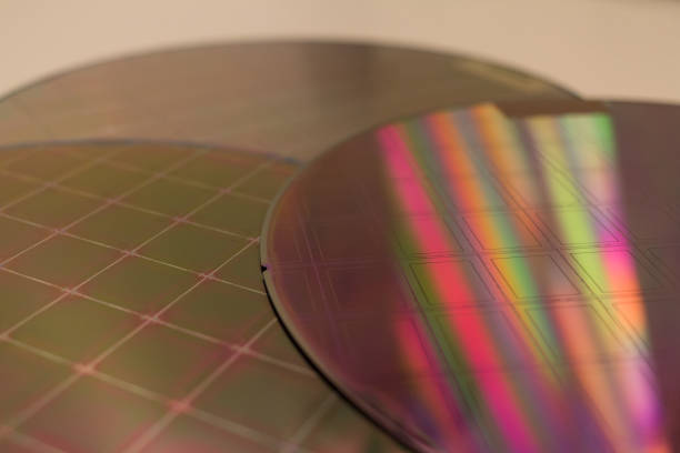 istock Silicon Wafers and Microcircuits - A wafer is a thin slice of semiconductor material, such as a crystalline silicon, used in electronics for the fabrication of integrated circuits. 1394732467