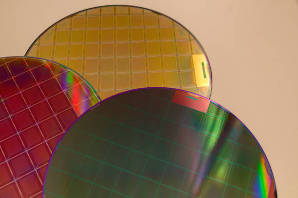 istock Silicon Wafers and Microcircuits - A wafer is a thin slice of semiconductor material, such as a crystalline silicon, used in electronics for the fabrication of integrated circuits. 1394732634