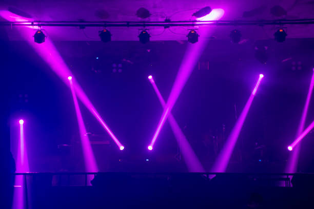 istock Spot light on stage and colors are change. Defocused people. 1394736213