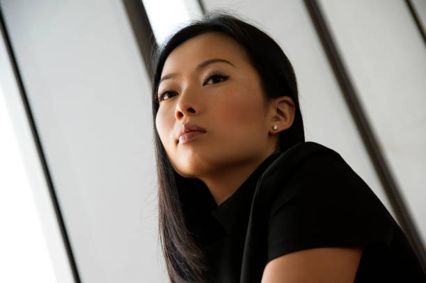 istock Focussed Asian Buisness Woman Looking Away from Camera 1394736462
