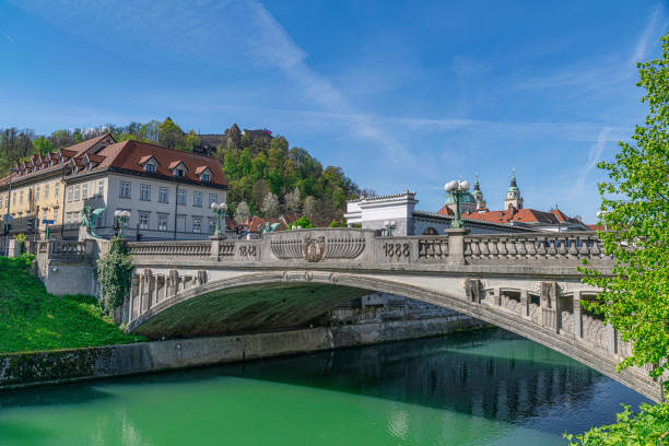 Springtime in Slovenia Dragon statues on Ljubljanas Dragon bridge on a bright sunny day, Ljubljana, Slovenia( Zmajski Most ) ljubljana castle stock pictures, royalty-free photos & images