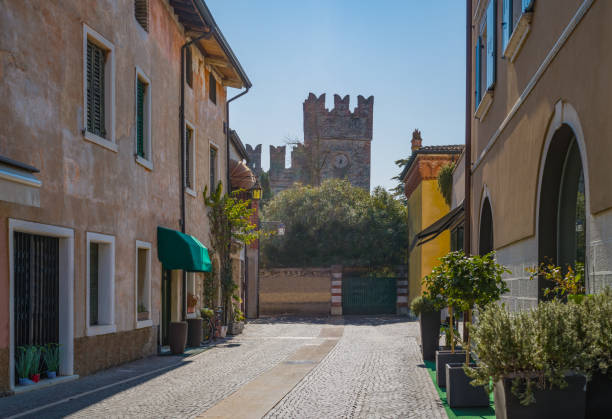 Italy, Lazise, a street of the old town with the Scaligero castle in the background