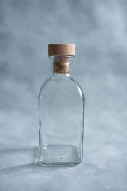istock transparent bottle with a cork on a gray background 1394739813
