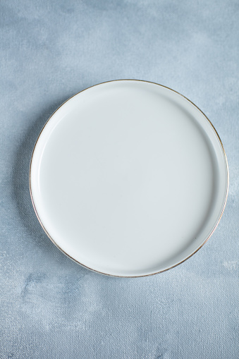white plate on a gray background for food blog