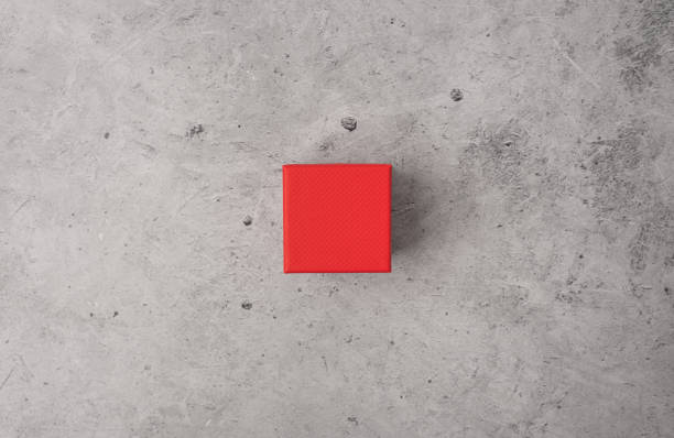 istock Little red gift box on a light concrete background. 1394739989