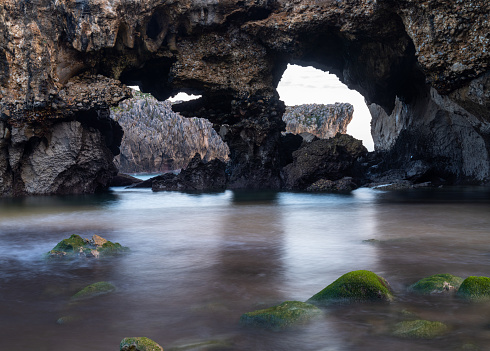 A detail view of the caves of the Cuevas del Mar beach in Asturias