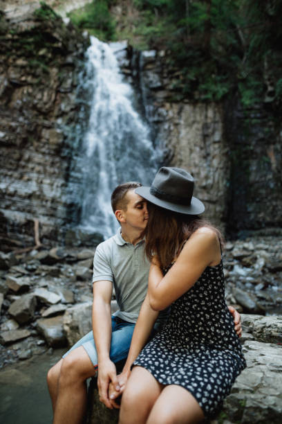 istock A cheerful couple at the waterfall background 1394743472