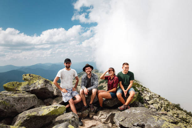 istock Four cheerful friends spend vacation in the mountains 1394744366