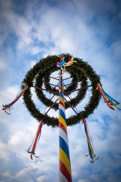 istock colorfully decorated maypole in nice weather and the sky is blue 1394745610