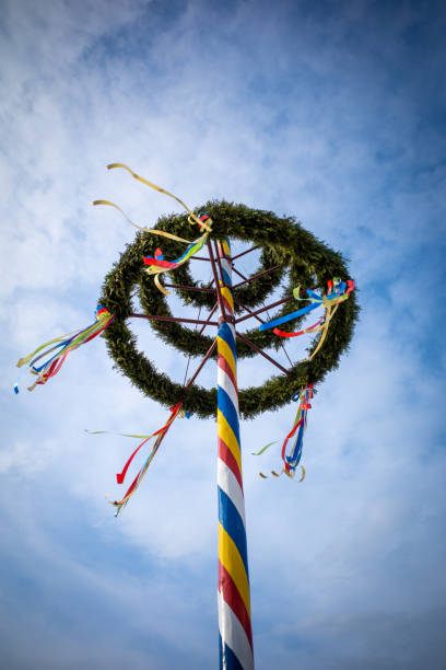 istock colorfully decorated maypole in nice weather and the sky is blue 1394745619