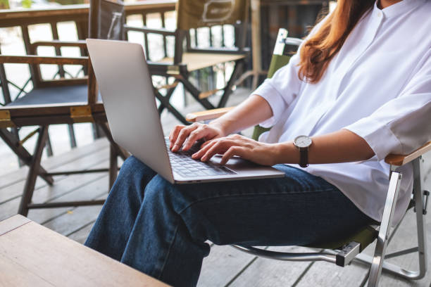 istock Closeup image of a young woman working and typing on laptop computer 1394745704