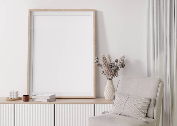 istock Empty vertical picture frame on white wall in modern living room. Mock up interior in contemporary, scandinavian style. Free, copy space for picture. Console, pampas grass. Close up. 3D rendering. 1394745744