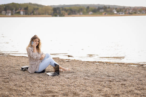 istock Young woman working on lakeshore 1394745895