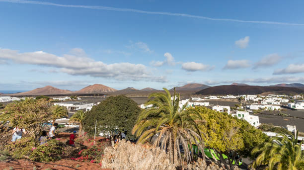 View of Yaiza the white town with the volcanoes on Timanfaya Park on the background in Lanzarote, Canary Islands in Spain stock photo