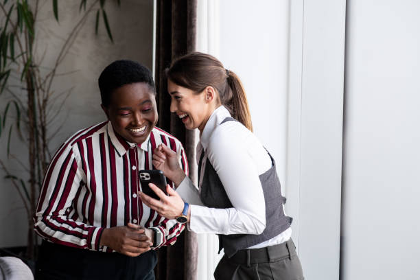 istock Two interracial female colleagues laughing 1394747892