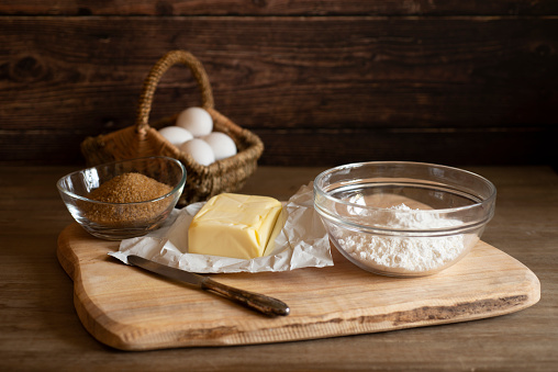 Preparation for baking - flour, one, butter in an old kitchen