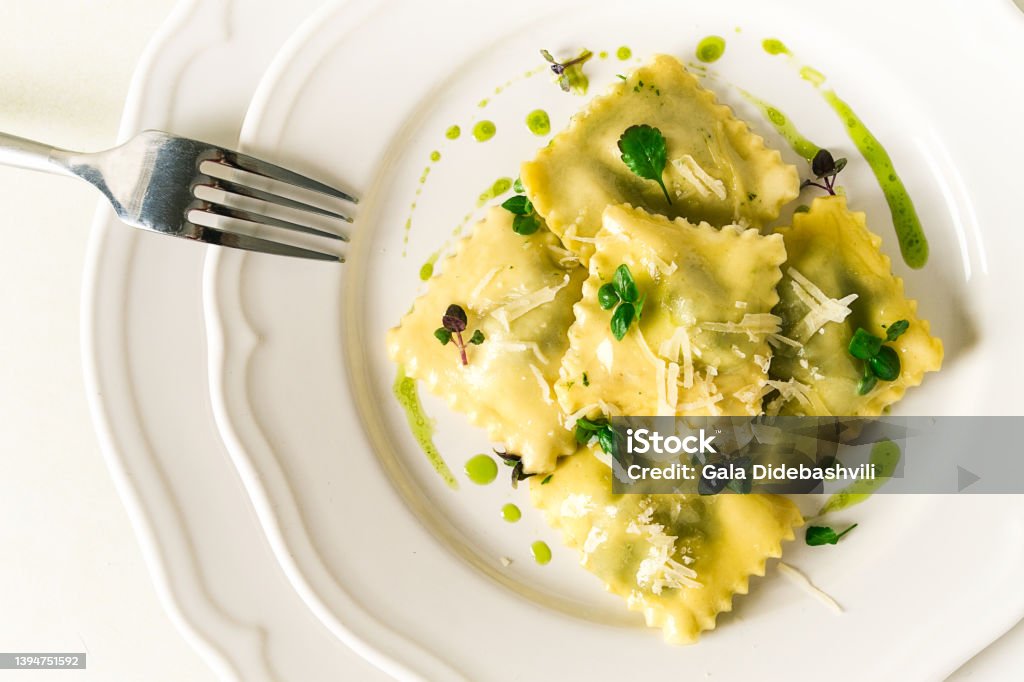 Ravioli with spinach and cheese, green sauce, on a light background, selective focus, no people, Ravioli Stock Photo