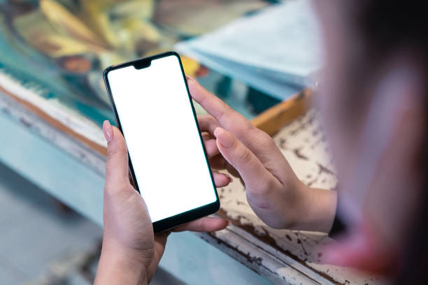 istock Female hands holding mobile phone, close-up 1394752163
