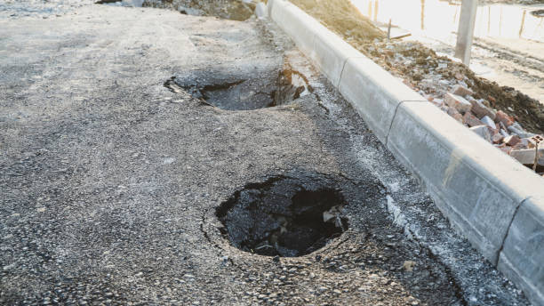 istock Asphalt swelling close-up. Pothole and pit on road 1394752212