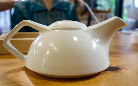 White teapot on the table in restaurant