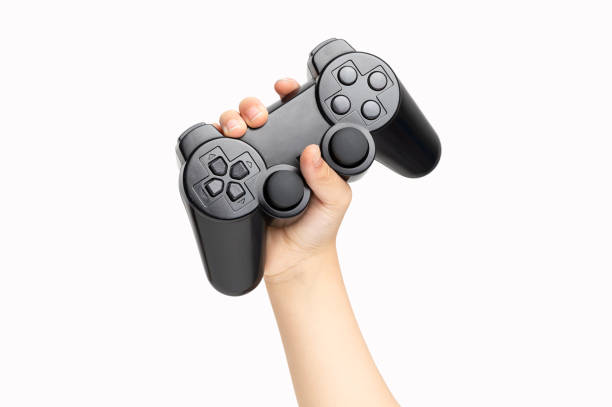 little boy holding black gamepad Shot of an little boy hand holding black gamepad show cool symbol on white background, minimalism concept. computer game control stock pictures, royalty-free photos & images