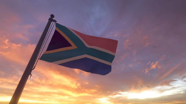 South Africa Flag on Flagpole by Evening Sunset Sky stock photo