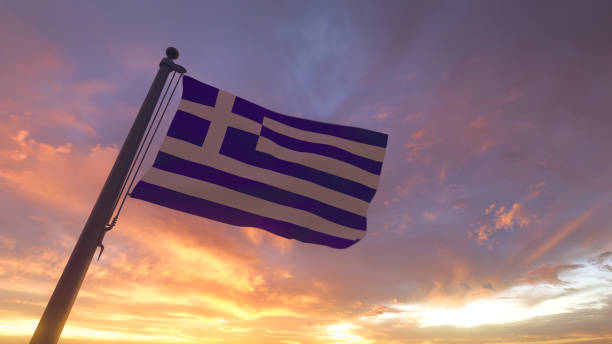 Greece Flag on Flagpole by Evening Sunset Sky stock photo