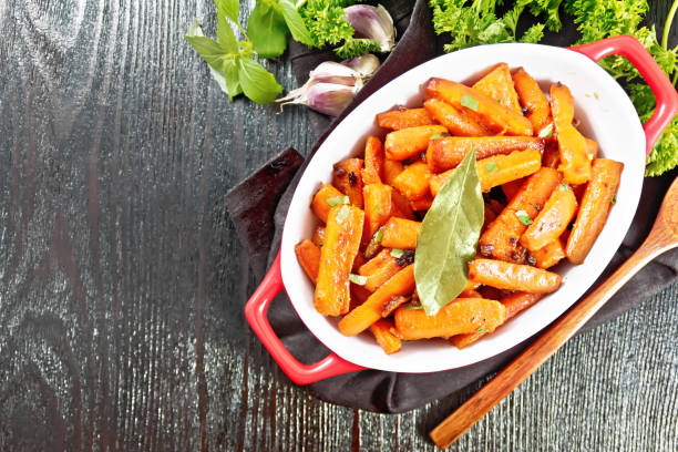 istock Carrots fried in pan on dark board top 1394757646