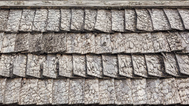 istock Traditional old wooden grey colour tiled roof. 1394757887