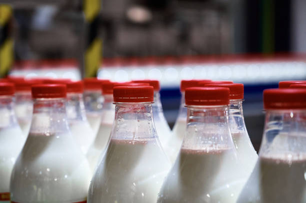 istock Plastic bottles filled with pasteurized milk on a factory conveyor. 1394758597