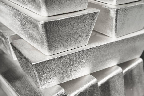 Stack of industrial silver ingots at bright light in storage stock photo