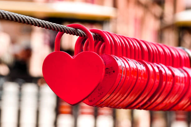 istock Small red shaped hearts locked to a steel cable 1394760222
