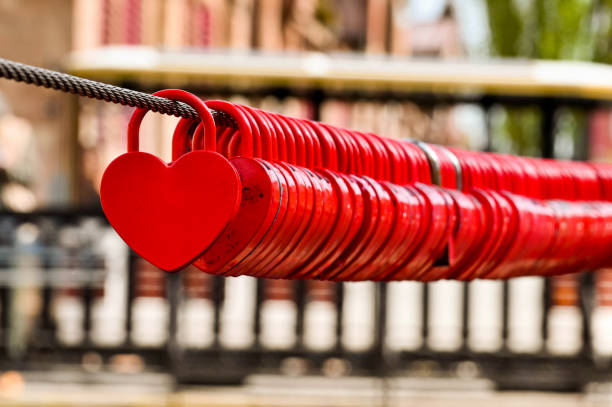 istock Small red shaped hearts locked to a steel cable 1394760229