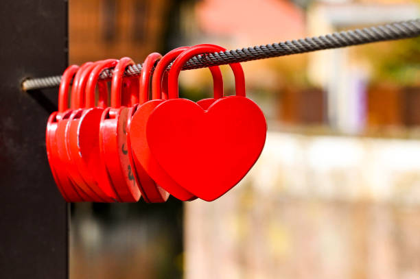 istock Small red shaped hearts locked to a steel cable 1394760233