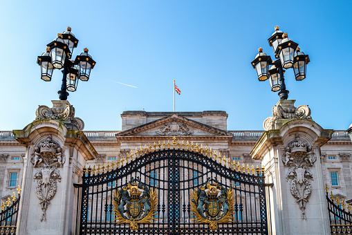 London Buckingham Palace front facade in a summer sunny blue sky day. Built in 1701 beside St James Park. Changing of the Guard takes place on the Buckingham Palace forecourt. It is the official residence of the British monarch in London.
