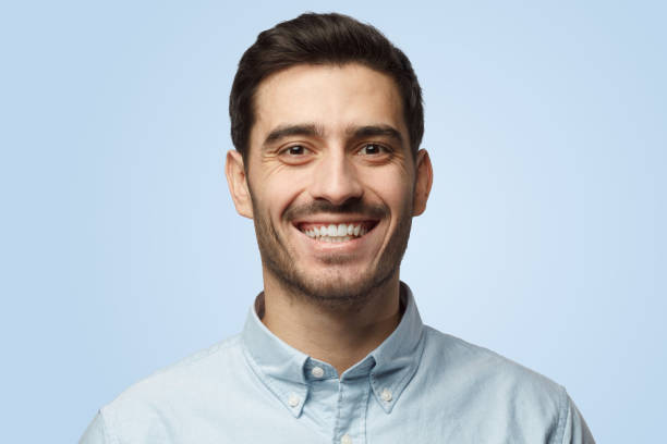 istock Stylish bearded attractive man smiles to camera having pleased expression 1394760876