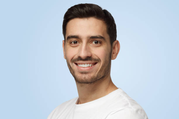 istock Attractive bearded man smiles to camera having pleased expression and cheerful look 1394760898