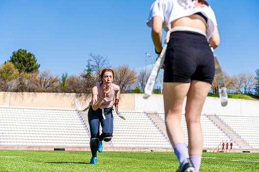 girls playing an intense game of rugby on the field with their friends