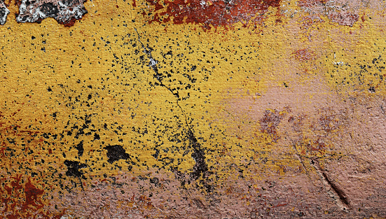 Yellow painted old concrete wall texture background.