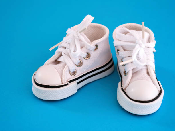 istock A white doll shoes on blue background 1394763402