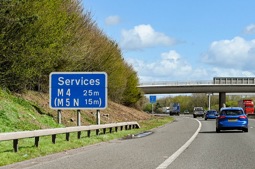 Bristol, England - April 2022: Road sign on the M4 motorway informing drivers of the distances to the next service stations.