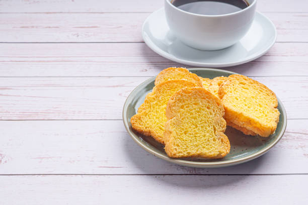 istock Crispy butter toast and a white coffee cup on wooden table 1394764514
