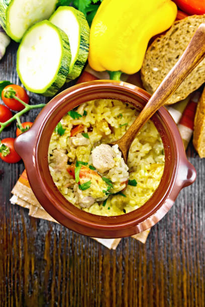 istock Rice with chicken and vegetables in pot on board top 1394764559