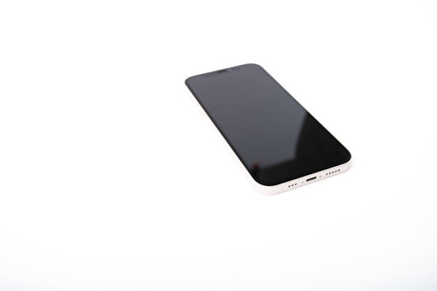 iPhone Apple 12 white isolated on white background,smartphone lies with the camera facing up, Russia,Moscow,April 20, 2022