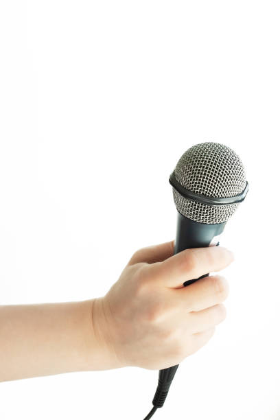 istock microphone is holding the hand of the press,isolated on a white background 1394765355
