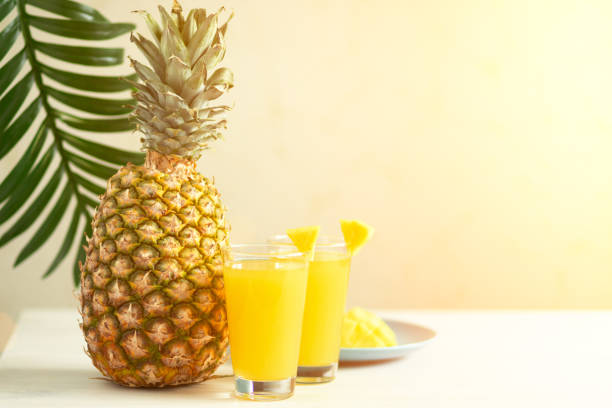 istock summer beach cocktail, pineapple juice on the table in a glass 1394765391
