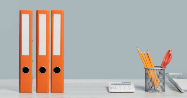 istock Colorful document binders or lever arch file on a shelf or desk banner 1394767776
