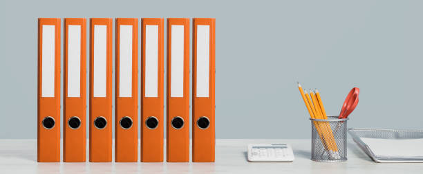 istock Colorful document binders or lever arch file on a shelf or desk banner 1394767934