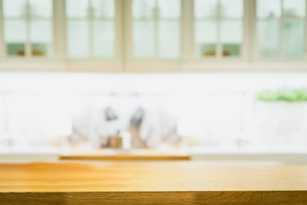 istock Wood table with blur kitchen room background .For montage product display or design key visual layout. 1394769408