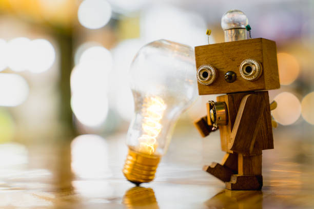 istock Retro wood robot hold light bulb with two hand with bokeh light background,, nature power energy concept. 1394769431